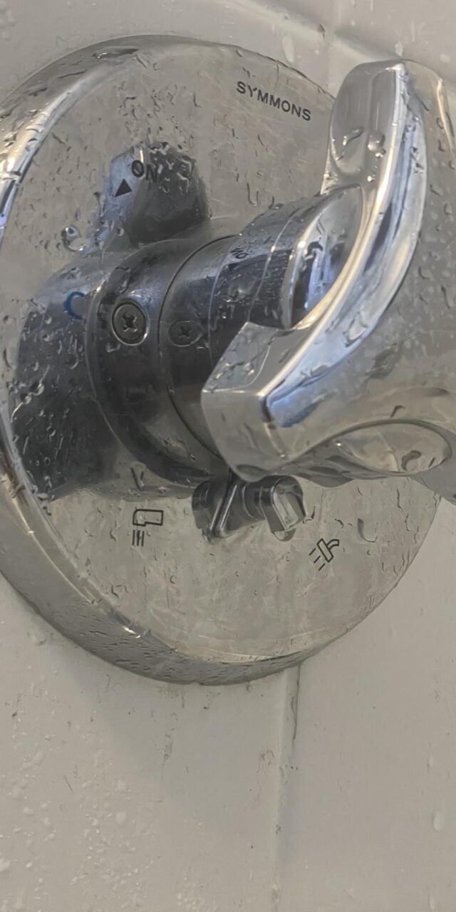 Close-up of a Symmons shower valve showing its durable design and precise temperature control.